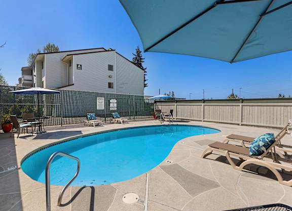 Resort Style Pool with Lounge Chairs in the Sun at Campo Basso Apartment Homes, WA 98087