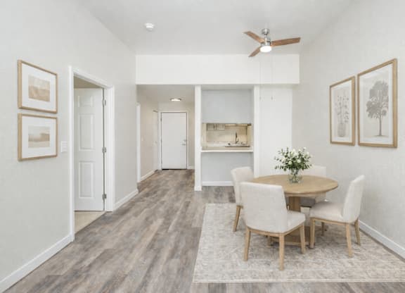 A dining room with a table and chairs.