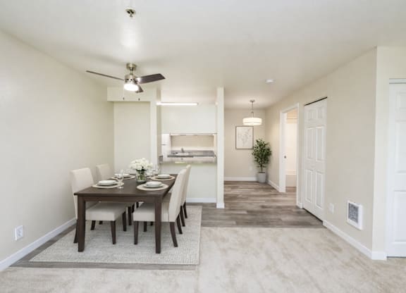 A dining room with a table set for six.