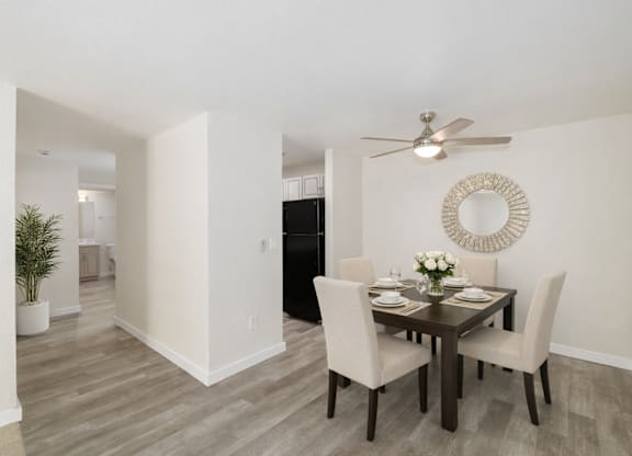 A dining room with a table set for four.