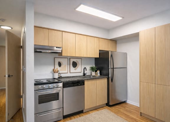 A kitchen with wooden cabinets and stainless steel appliances.