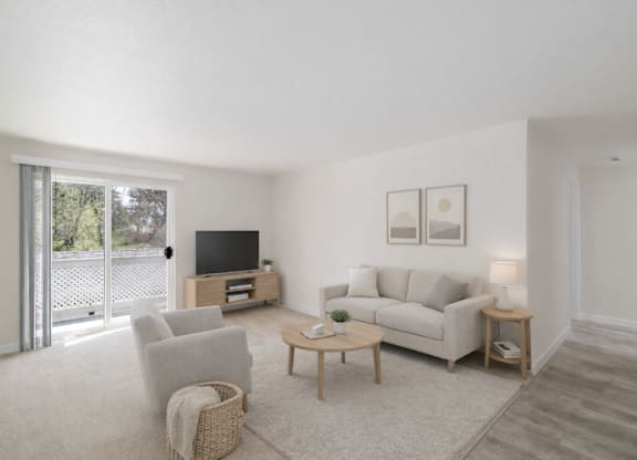 A living room with a white couch, a wooden coffee table, and a television.