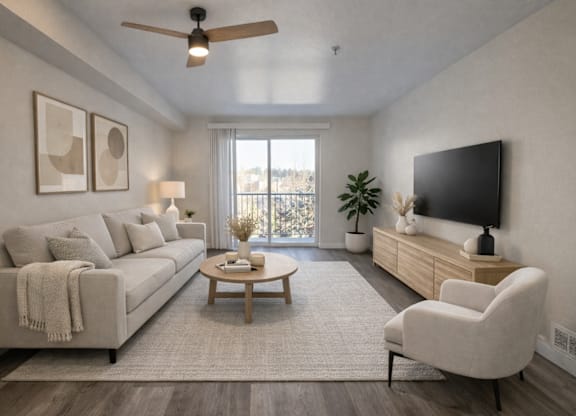 A living room with a couch, a chair, a coffee table, and a flat-screen TV.