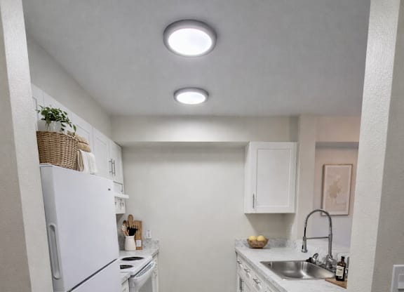 A kitchen with white appliances and a white refrigerator.
