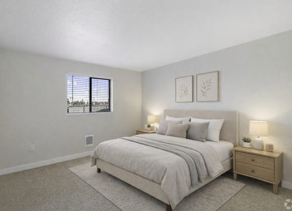 A bedroom with a bed, nightstand, and two framed pictures on the wall.