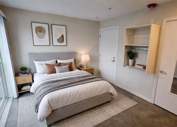 A bedroom with a large bed and a built-in closet.