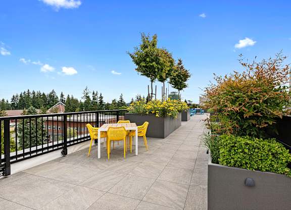 Well Landscaped terrace area with a table and chairs at Arabella Apartment Homes, Shoreline, 98155