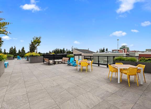 a resident rooftop terrace with tables and chairs at Arabella Apartment Homes, Shoreline, Washington 98155