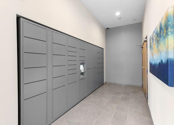 a row of package lockers with a painting on the wall at Arabella Apartment Homes, Shoreline