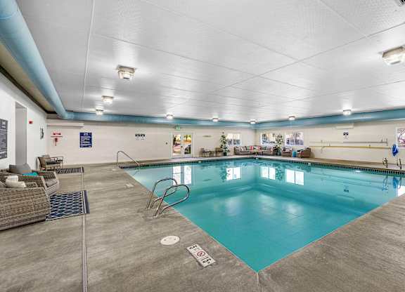 a large indoor swimming pool with a diving board  at Camelot Apartment Homes, Washington