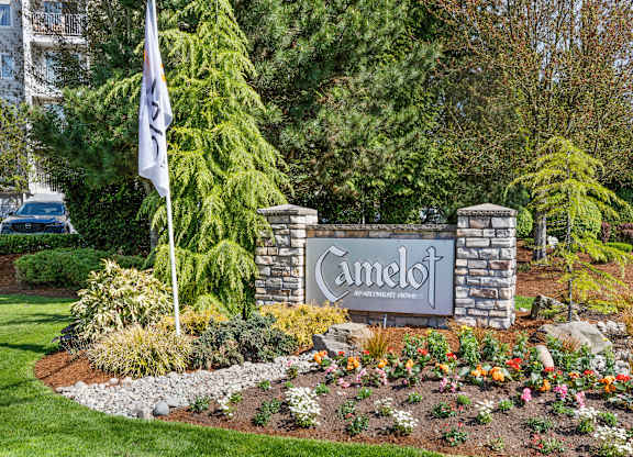 a sign in front of a building with a flag