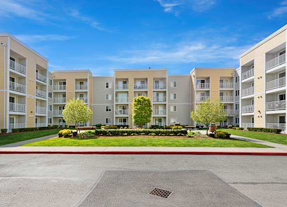 a picture of an apartment complex with a blue sky in the background  at Camelot Apartment Homes, Washington, 98204