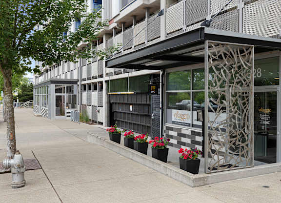 View of the property entrance from the side with artsy iron patio wall at Villaggio Apartment Homes, Tacoma, Washington 98402