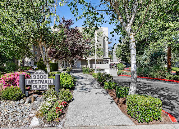 a walkway with small shrubs and property address sign at West Mall Place Apartment Homes, Everett, WA, 98208