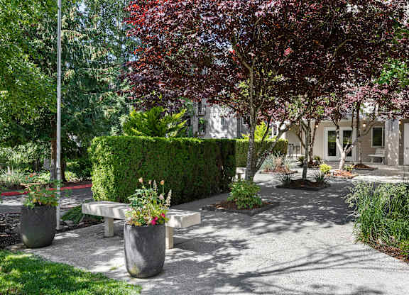 Property Courtyard with benches and planters in front for resident enjoyment at West Mall Place Apartment Homes, Everett, WA, 98208
