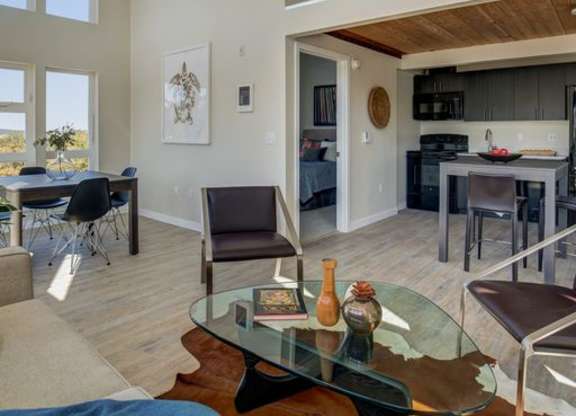 a living room with a glass table and chairs
