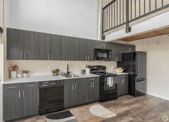 A modern kitchen with dark wood cabinets and stainless steel appliances.