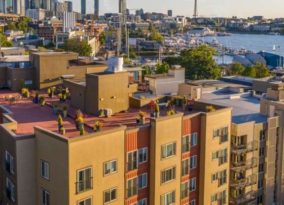 View from the Resident Rooftop Deck of a Puget Sound and the city of Seattle in the background at Illumina Apartment Homes, Washington, 98102