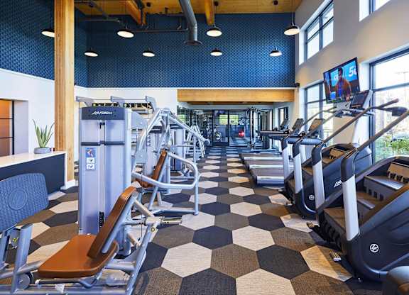 A gym with treadmills and exercise equipment.at Postmark Apartments, Shoreline