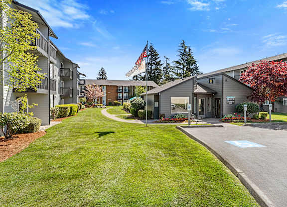 Grassy Courtyard Area with grass and Tress Outlining the Area at Pacific Park Apartment Homes, Edmonds, Washington 98026