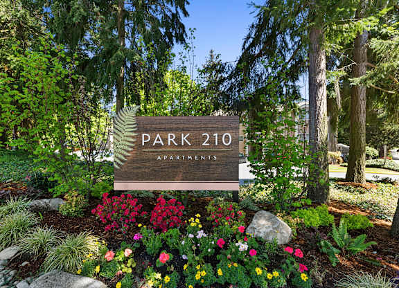 Park 201 Welcome Sign with Expertly Manicured Flowers and Trees at Park 210 Apartment Homes, Edmonds, Washington