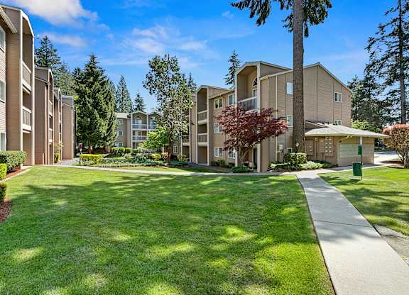 Apartment Buildings Surrounded by Grassy Area with Trees at Park 210 Apartment Homes, Washington, 98026