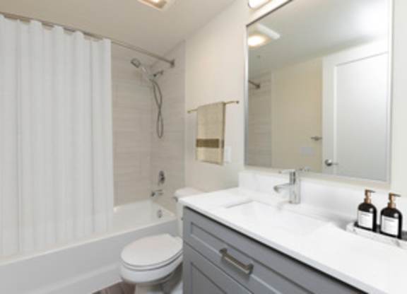 a bathroom with a sink toilet and a shower at Illumina Apartment Homes, Seattle, WA, 98102