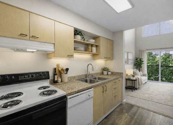 A modern kitchen with a black stove top oven and wooden cabinets.