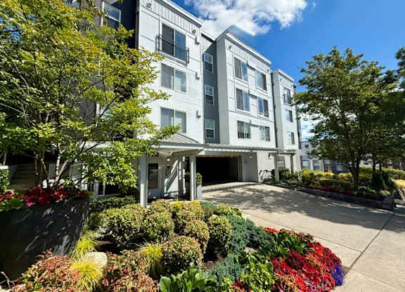 A modern building with a landscaped front yard.