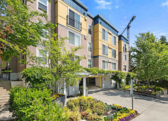 a large apartment building with a crane in the background at Sir Gallahad Apartment Homes, Bellevue, Washington 98004