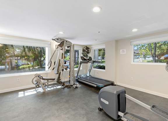 Fitness Facilities with a Treadmill, Weights, and Oversized Windows for an Abundance of Light  at Sir Gallahad Apartment Homes, Bellevue, WA