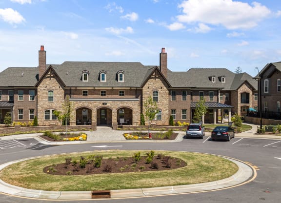 a large brick building with two chimneys and a roundabout in front of it at Griffin Weston, North Carolina, 27513