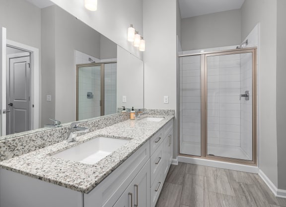 a bathroom with a large mirror and a shower with a glass door  at Griffin Weston, North Carolina