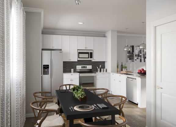 Townhome kitchen with stainless steel appliances, dining area, and granite countertops  at Griffin Weston, Cary
