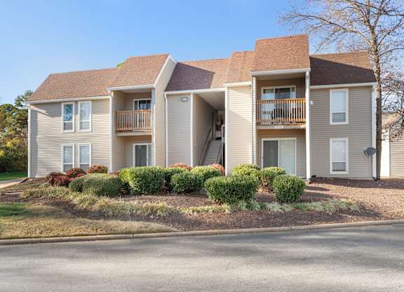A two-story apartment building with a balcony on the second floor at Lakes Edge Apartments, North Carolina