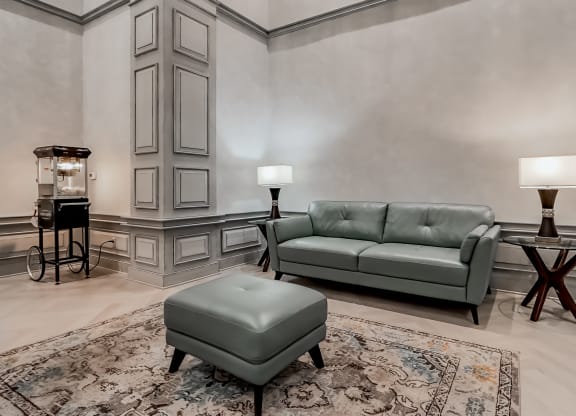a living room with a leather couch at The Mark at Dulles Station, Herndon