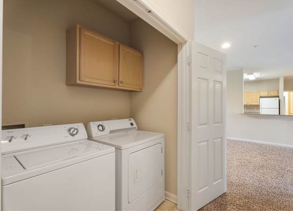 A laundry room with a washer and dryer. at Village on the Lake Apartments, Apartments, Spring Lake, NC