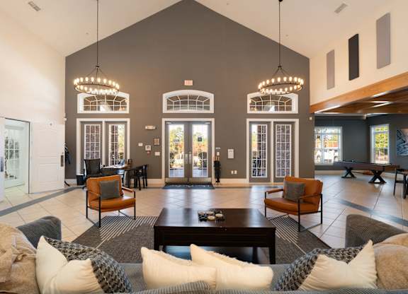 A large, open living room with a grey couch and a coffee table at Stone Gate Apartments, North Carolina