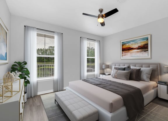 a bedroom with a large bed and two windows at Northlake Park, Orlando, FL