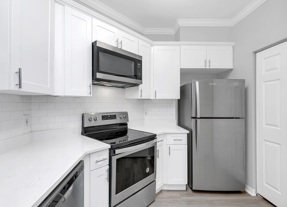 a kitchen with white cabinets and stainless steel appliances at Northlake Park, Orlando, FL, 32827