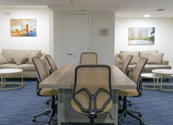 a conference room with a table and chairs and a couch at The Aspen, Virginia, 22305