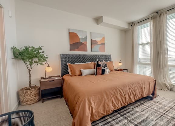 a bedroom with a bed and a chair and a window at Makers Rise, Virginia, 20171