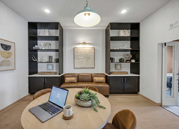 A modern living room with a laptop on the table.