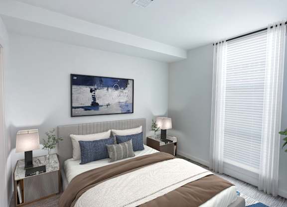 A bedroom with a large bed, two lamps, and a painting on the wall.at Makers Rise, Herndon, VA 20171  