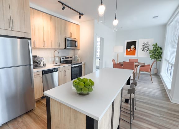 a kitchen with stainless steel appliances and a white counter top at Makers Rise, Herndon Virginia  