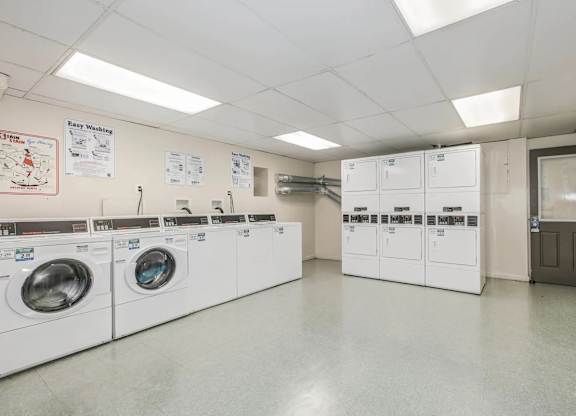 A laundry room with washing machines and a sign at Park Georgetown Apartments, Arlington, Virginia