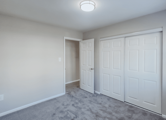 an empty bedroom with two closets and a door to a hallway at Middletown Valley, MD, 21769