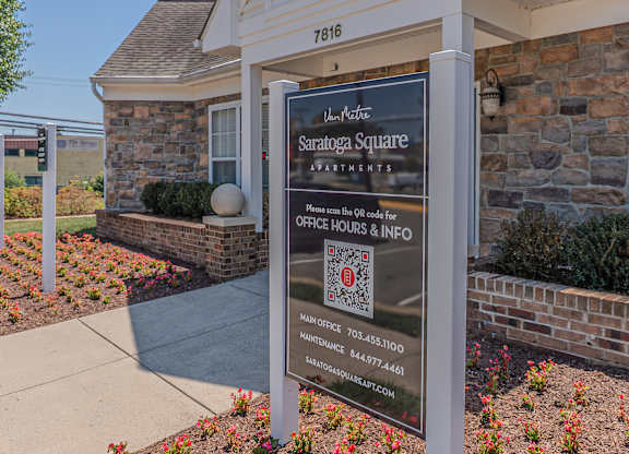 A sign for Saratoga Square Apartments is displayed in front of a building.