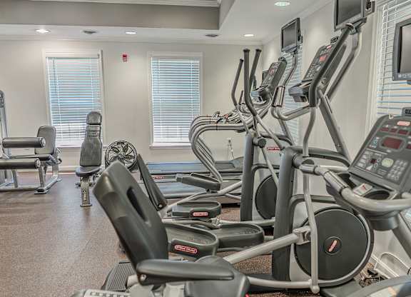 A gym with treadmills and elliptical machines.