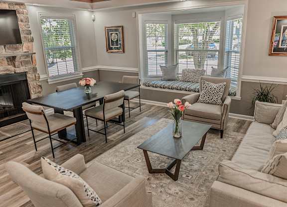 A living room with a fireplace and a dining table.